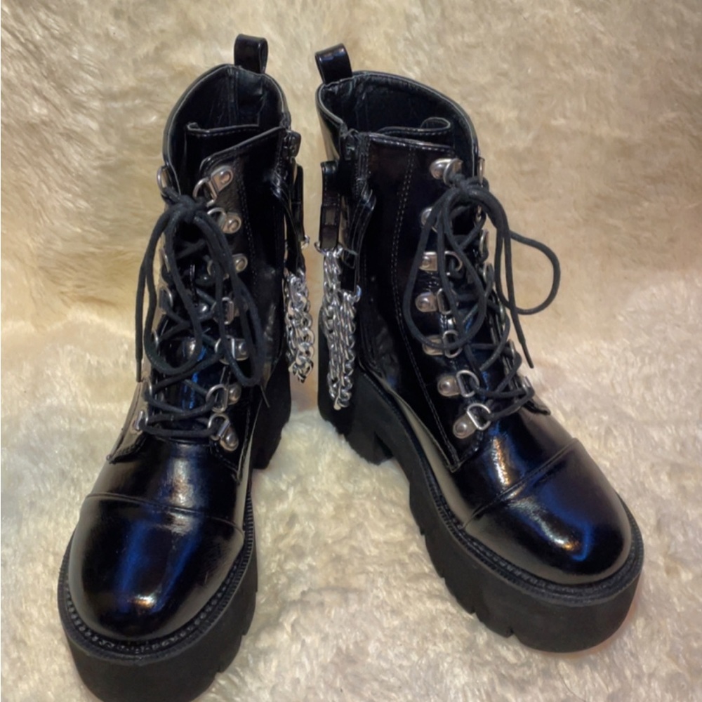 Black platform shoes, size 5 in women’s, chain on side of both shoes